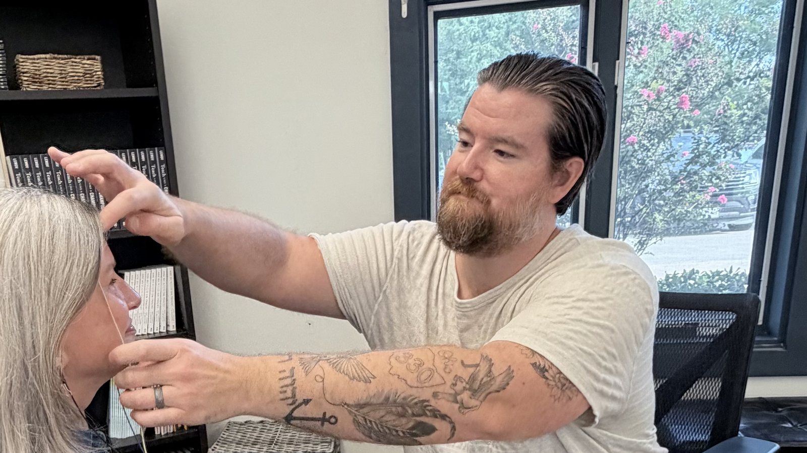 Rhett Edwards placing LENS neurofeedback sensors before a session in his Spring, TX office
